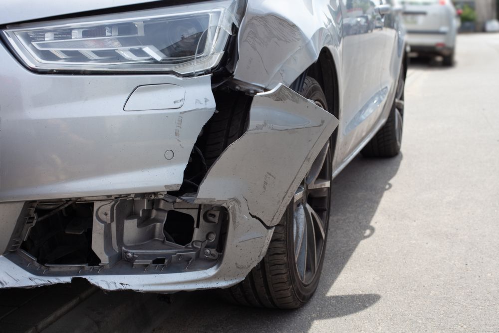 silver car with frame damage