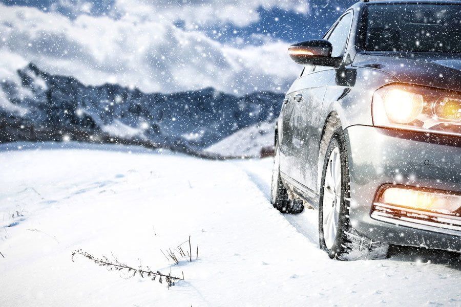 A car driving on a snowy road.