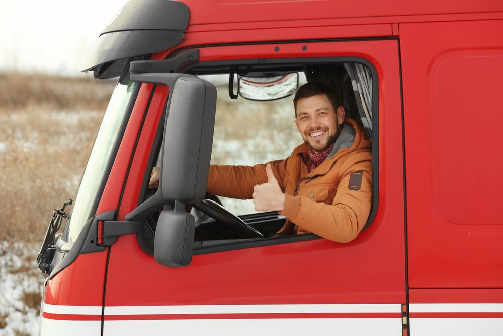 Driving Giving Thumbs Up In Red Truck — Reliable Driver Training in Darwin, NT