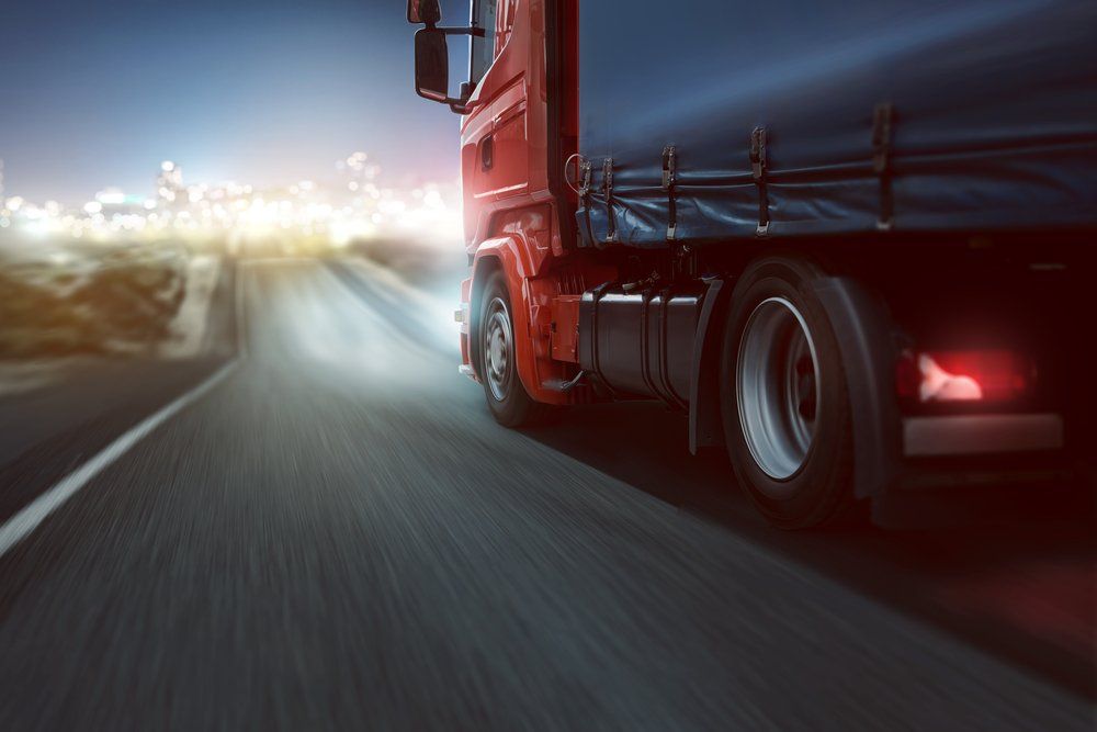 Red Truck Driving At Night — Reliable Driver Training in Darwin, NT