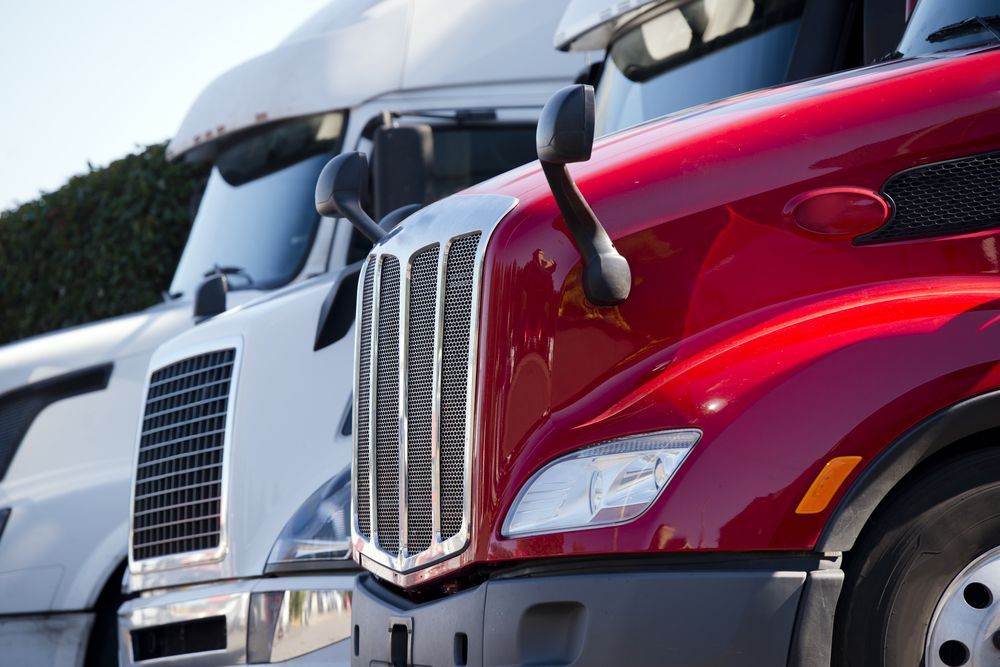 Red And White Trucks — Reliable Driver Training in Darwin, NT