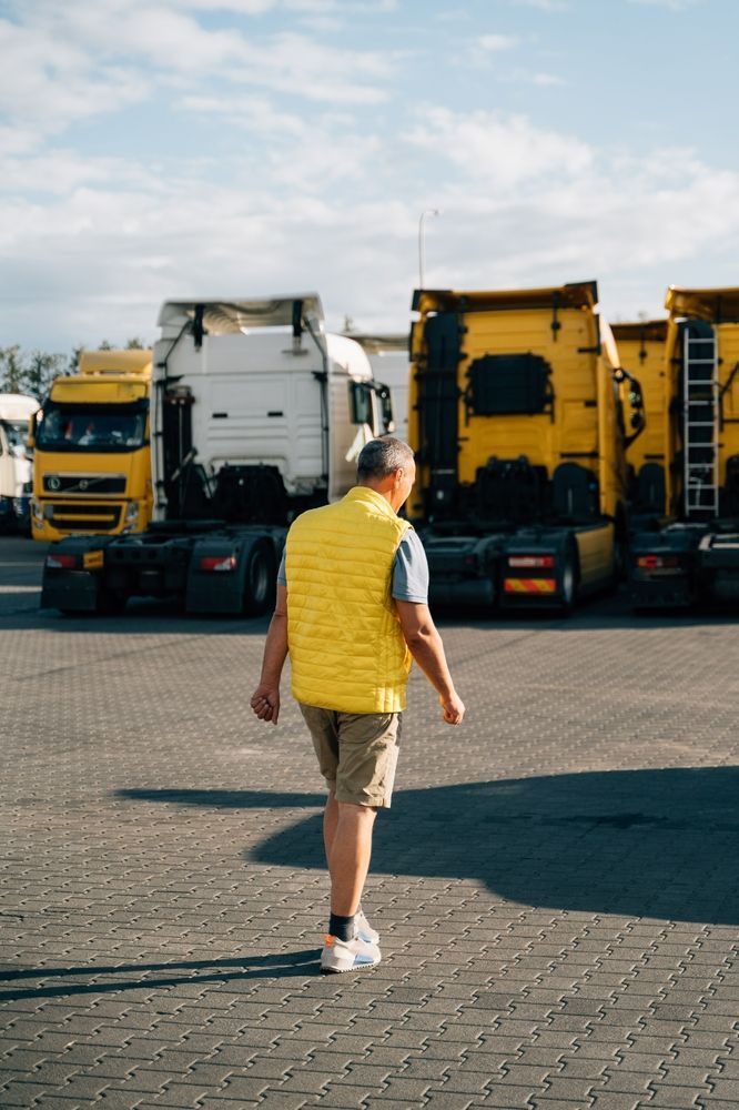 Person Walking Towards Trucks — Reliable Driver Training in Darwin, NT