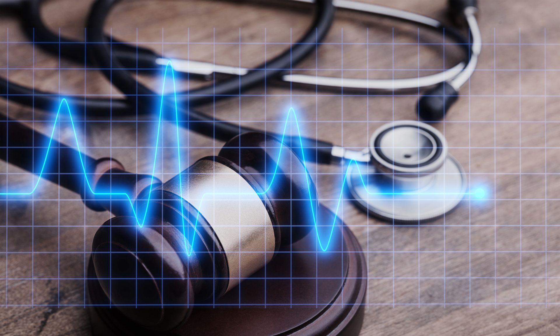 Gavel with stethoscope overlayed by a blue, electronic heartbeat graph.