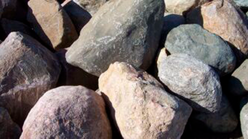 Close-up of assorted gray and brown rocks piled together