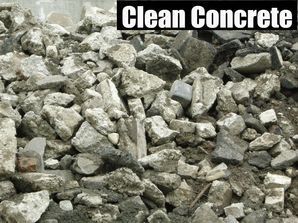 Pile of gray crushed concrete rubble with the words “Clean Concrete” at the top