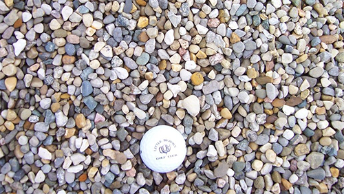 White plastic cap on multicolored gravel stones