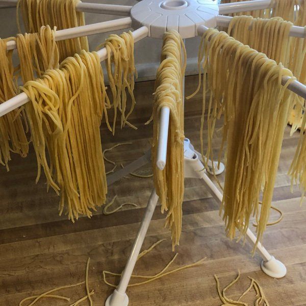 A bunch of noodles are hanging on a rack