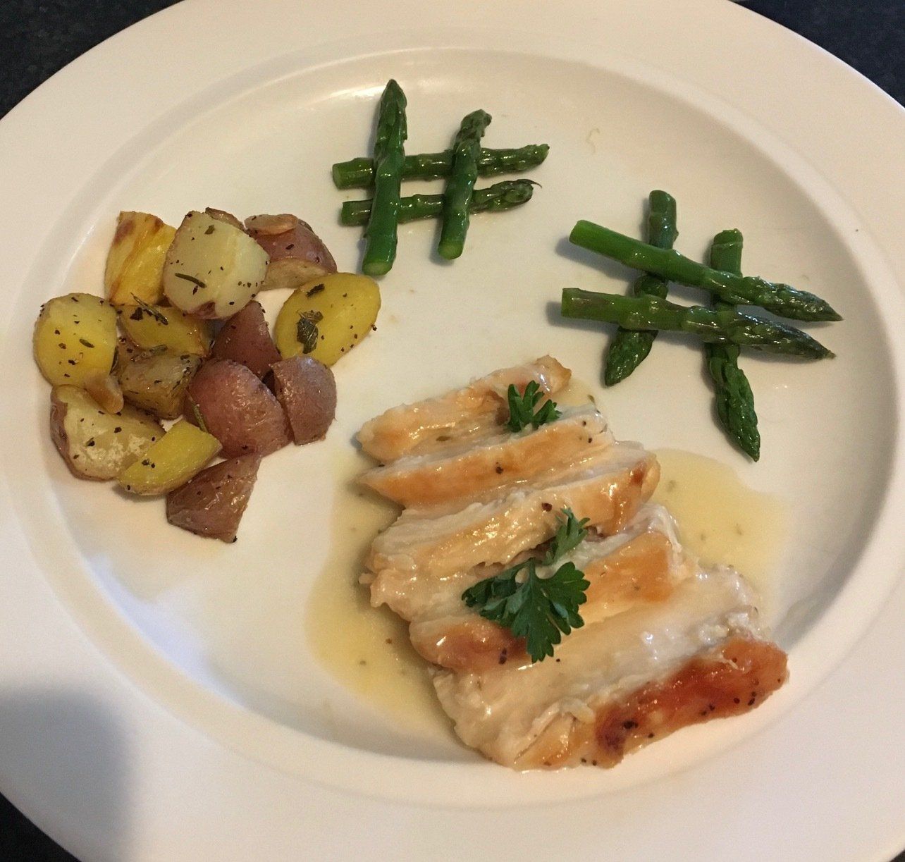 A white plate topped with chicken potatoes and green beans