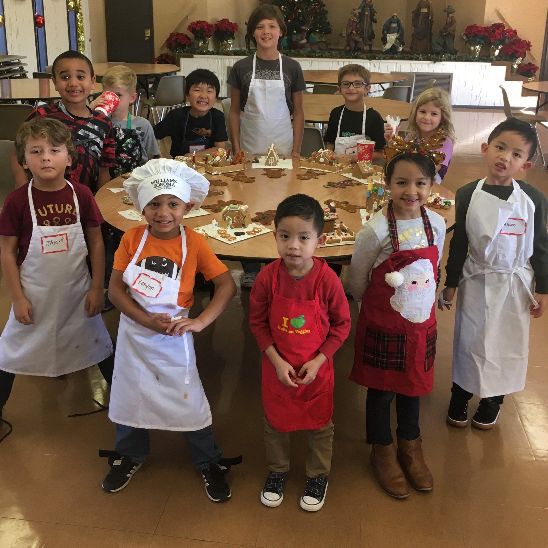 A group of children wearing aprons are posing for a picture