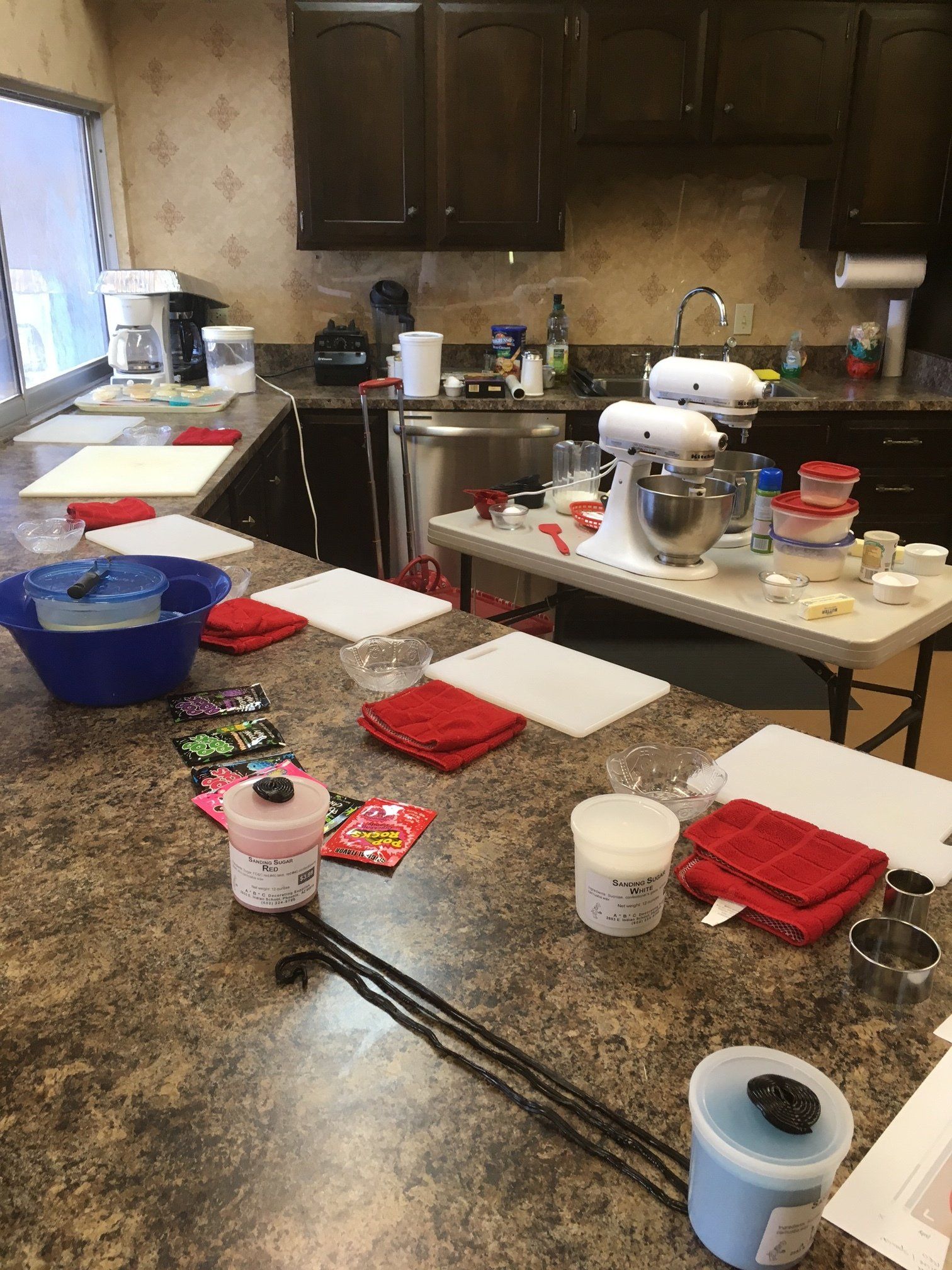 A kitchen with a lot of cooking supplies on the counters.