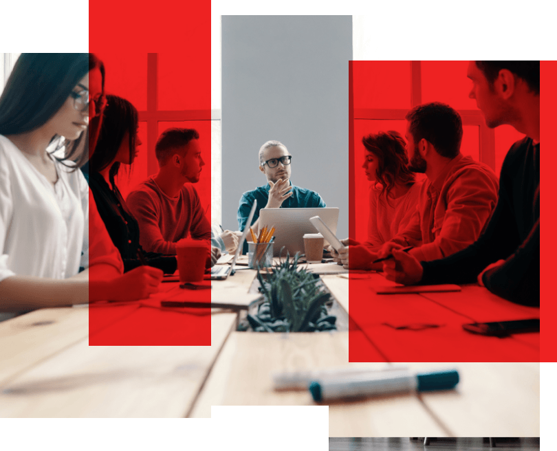 A group of people are sitting around a table having a meeting.
