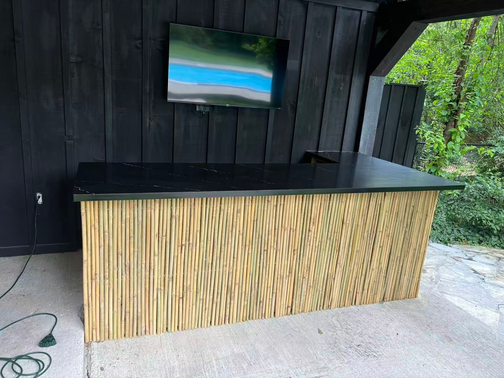 Custom outdoor bar with countertop and wood paneling