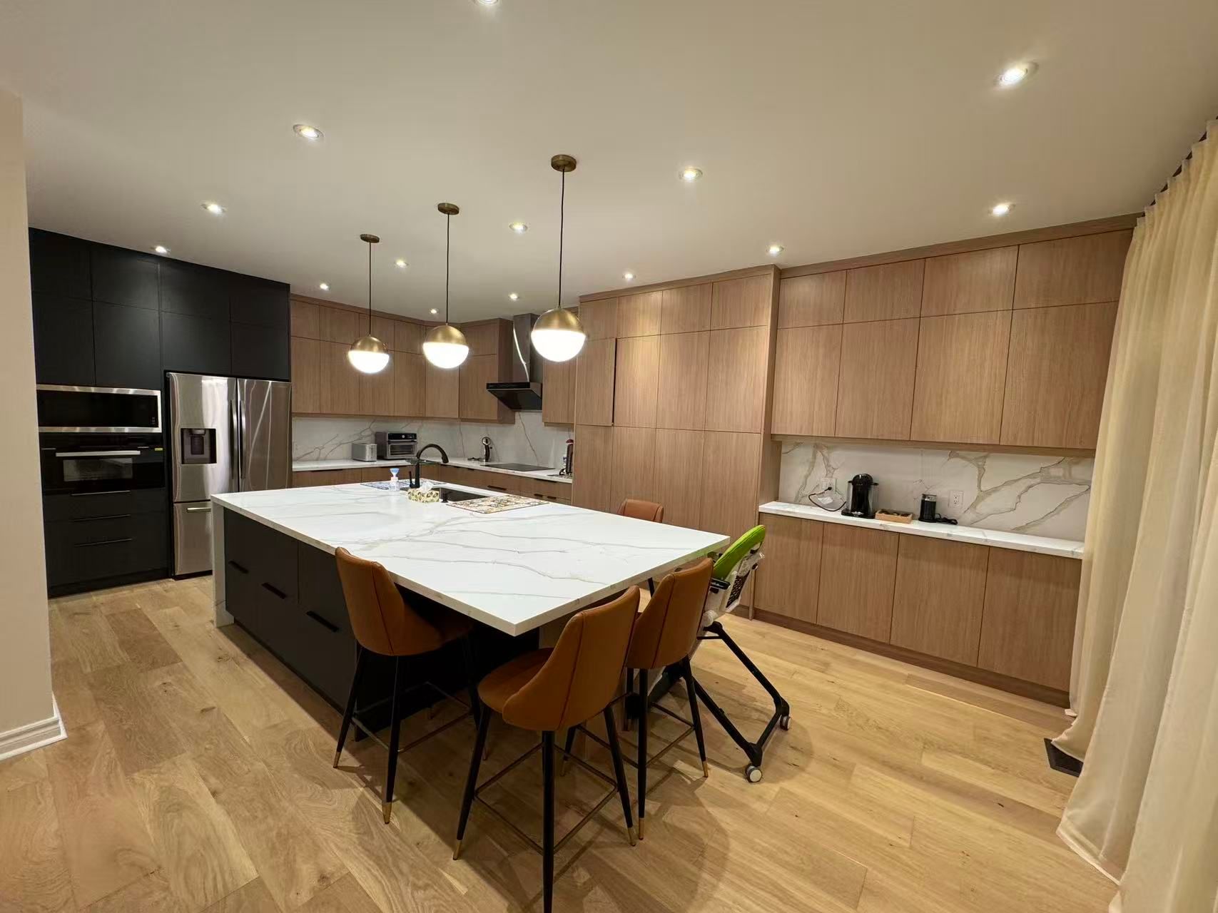 Modern wood kitchen cabinets with quartz countertops and large island in London, Ontario
