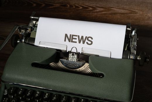 Typewriter with a paper labeled “NEWS” inserted in the carriage