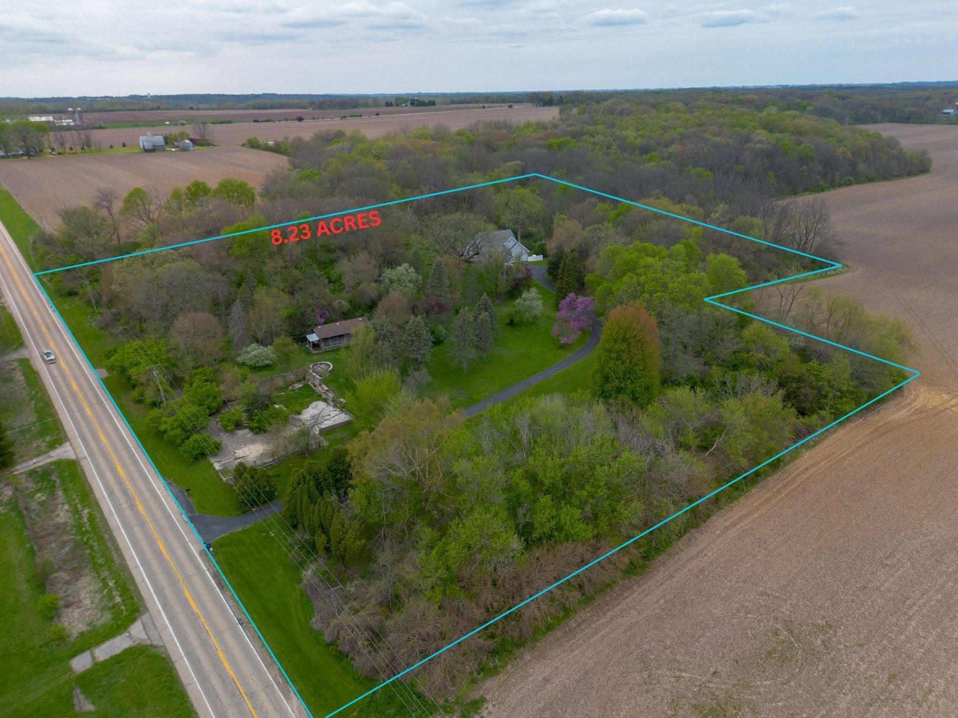 Aerial drone property image with illustrative boundary lines overlaid