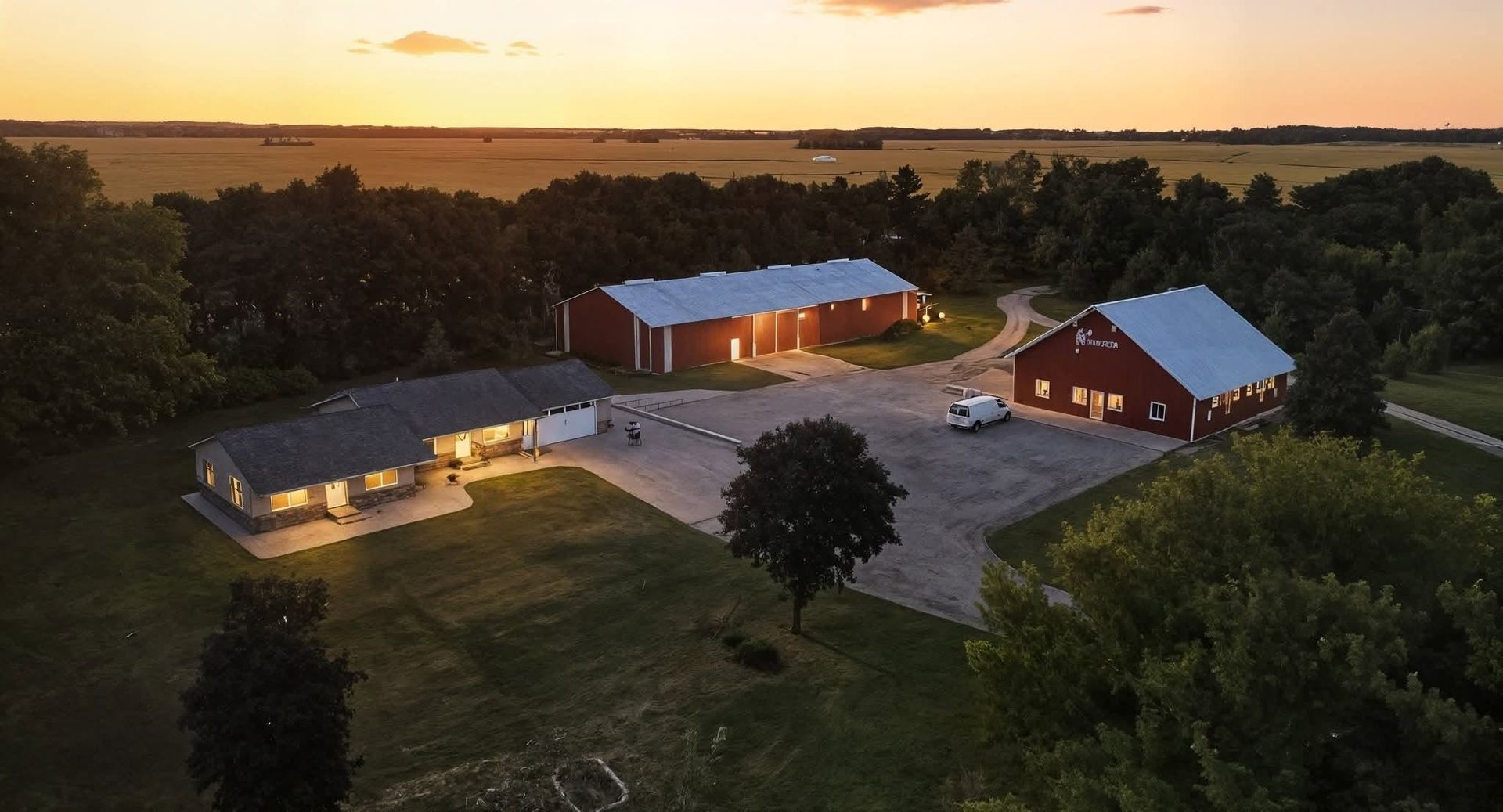 Evening aerial drone presentation of a rural home and outbuildings
