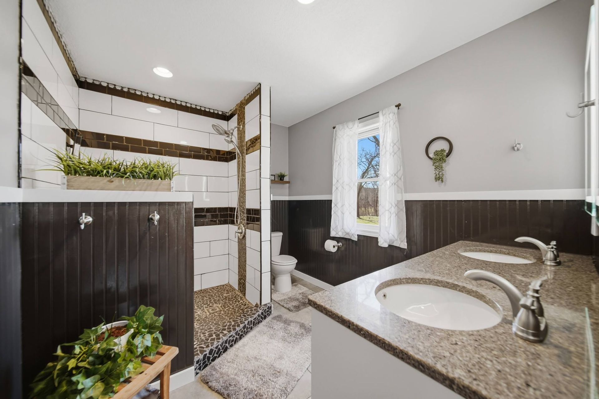Bathroom with a tiled shower, glass enclosure and double vanity