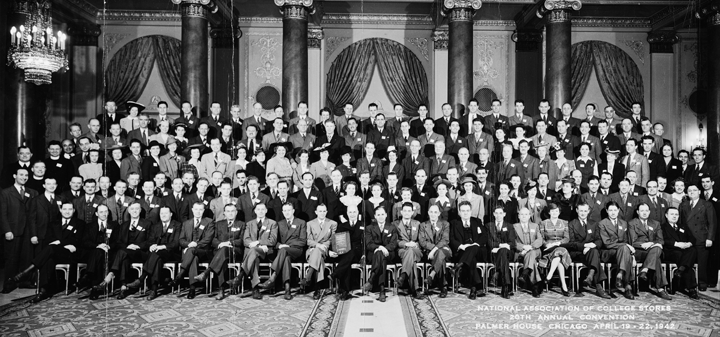 A large group of people are posing for a picture in a room.