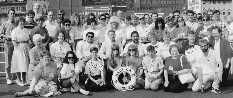 A large group of people are posing for a picture in a black and white photo.
