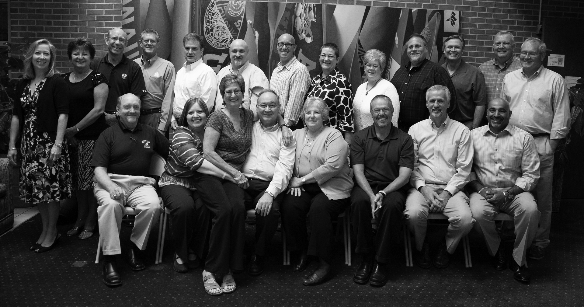 A group of people are posing for a picture in a black and white photo.