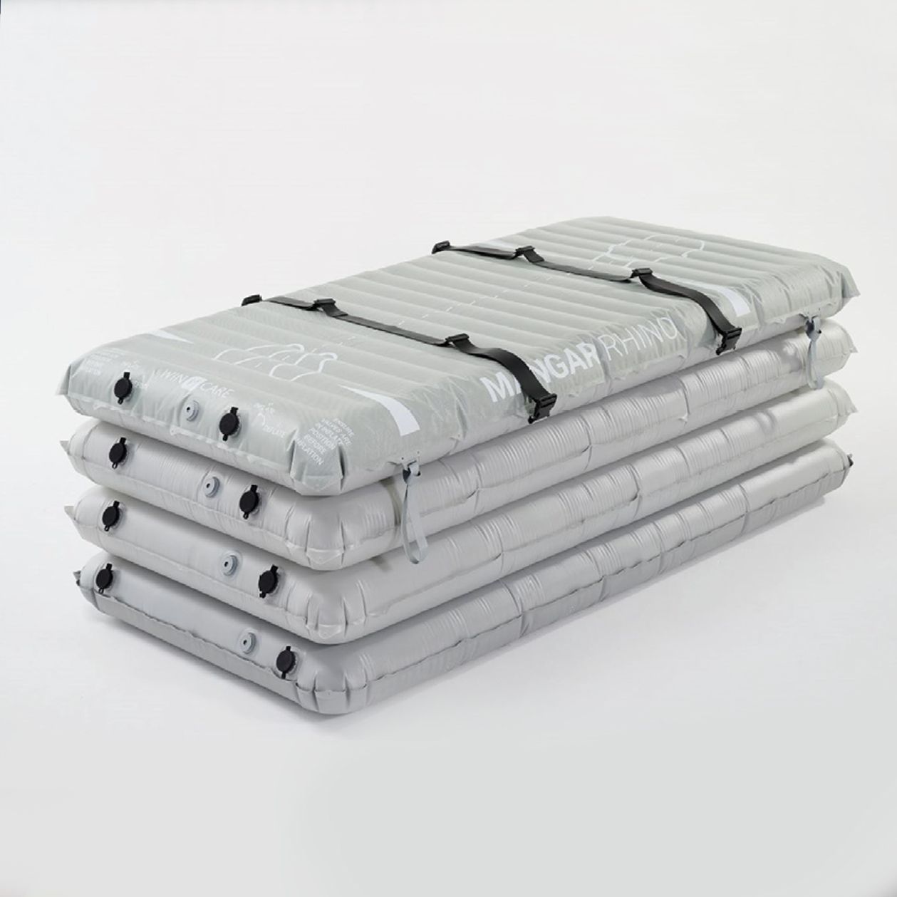 Four stacked, gray, inflatable sleeping pads secured with black straps.