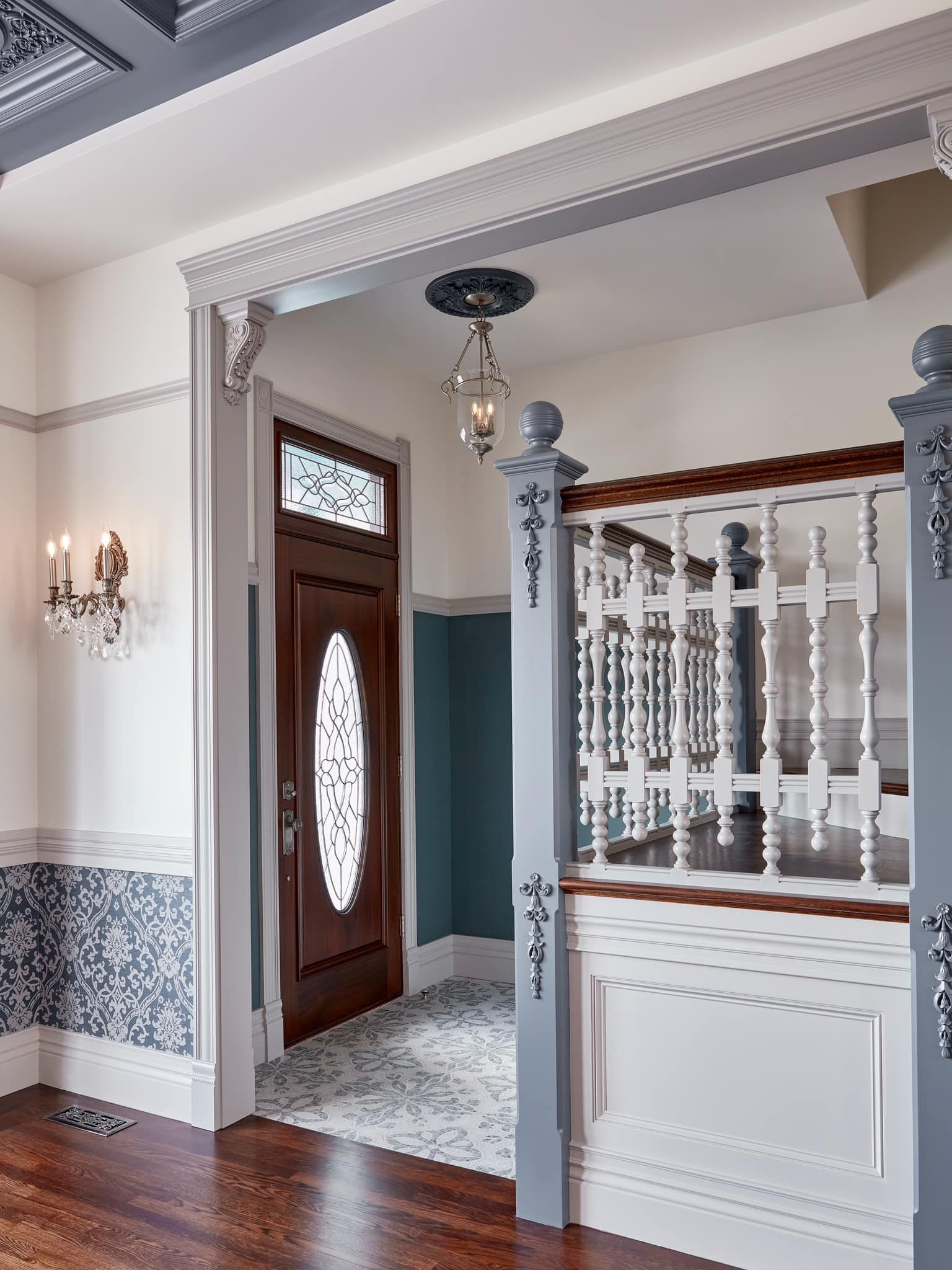 A hallway with a wooden floor and a stained glass door