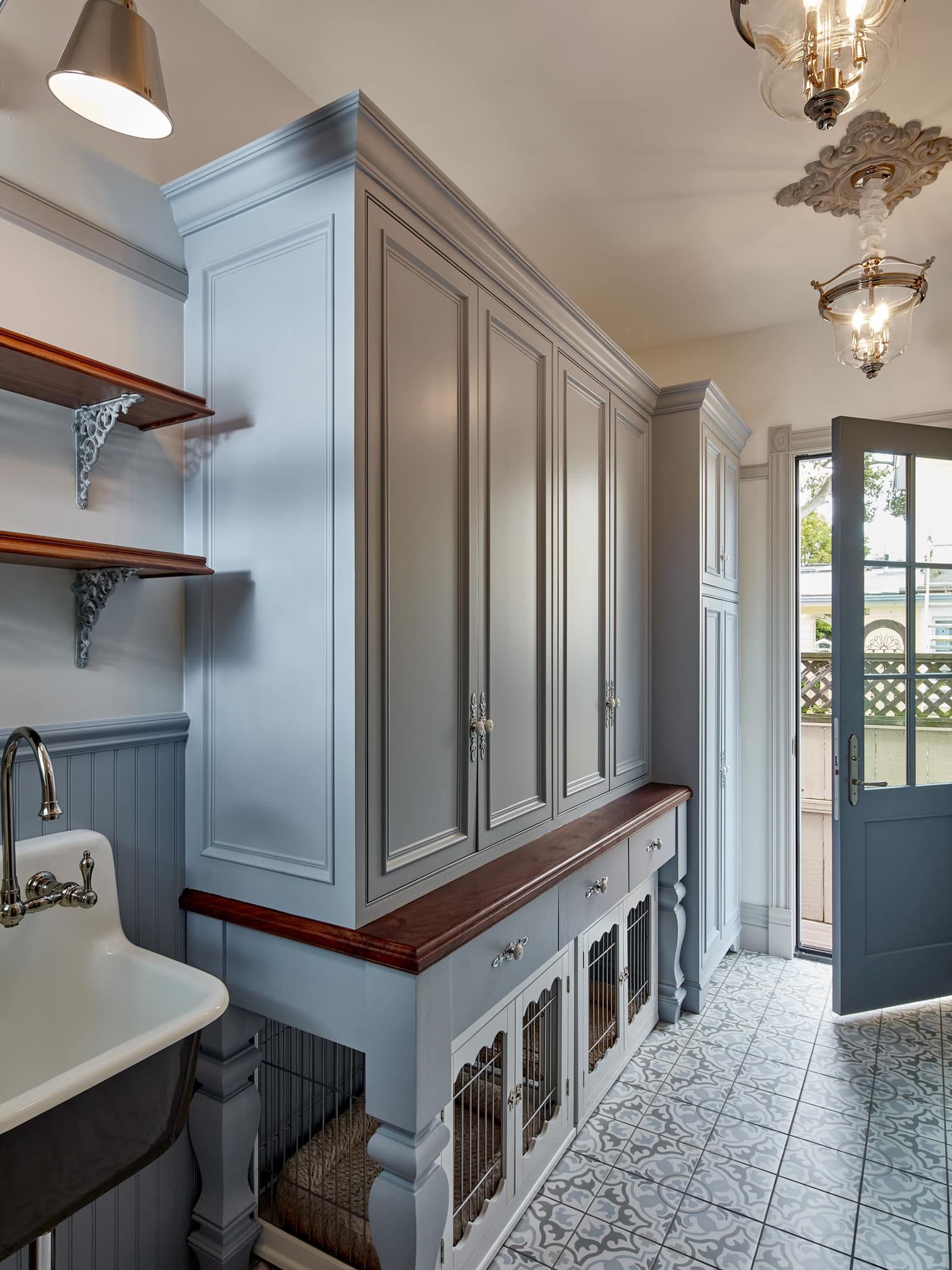 A laundry room with lots of cabinets and a sink