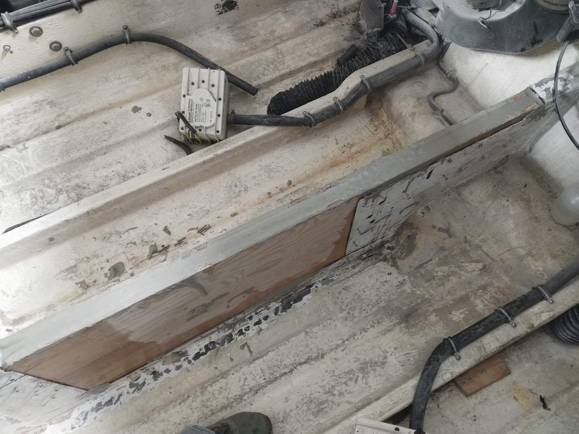 Dirty rooftop with HVAC ducts and black cables running across a white metal surface
