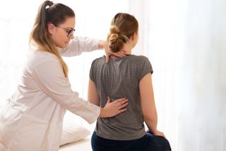A Doctor Checking The Spine — Powell, Ohio — Dublin Family PT A Doctor Checking The Spine — Powell, Ohio — Dublin Family PT