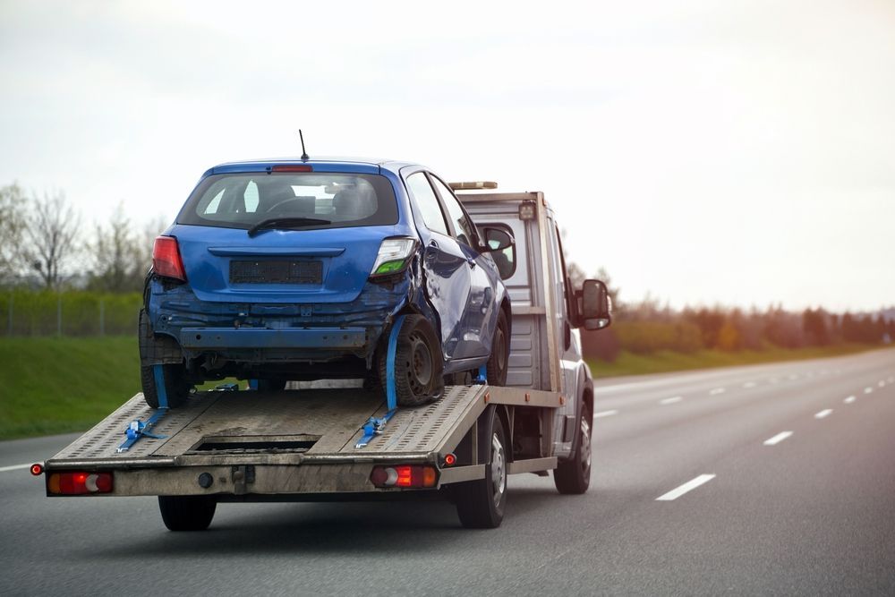 Damaged Car on Tilt Tray Tow Truck