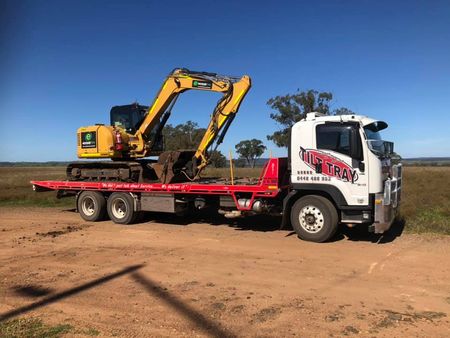 Truck Transporting Machinery — Towing in Dubbo, NSW Truck Transporting Machinery — Towing in Dubbo, NSW