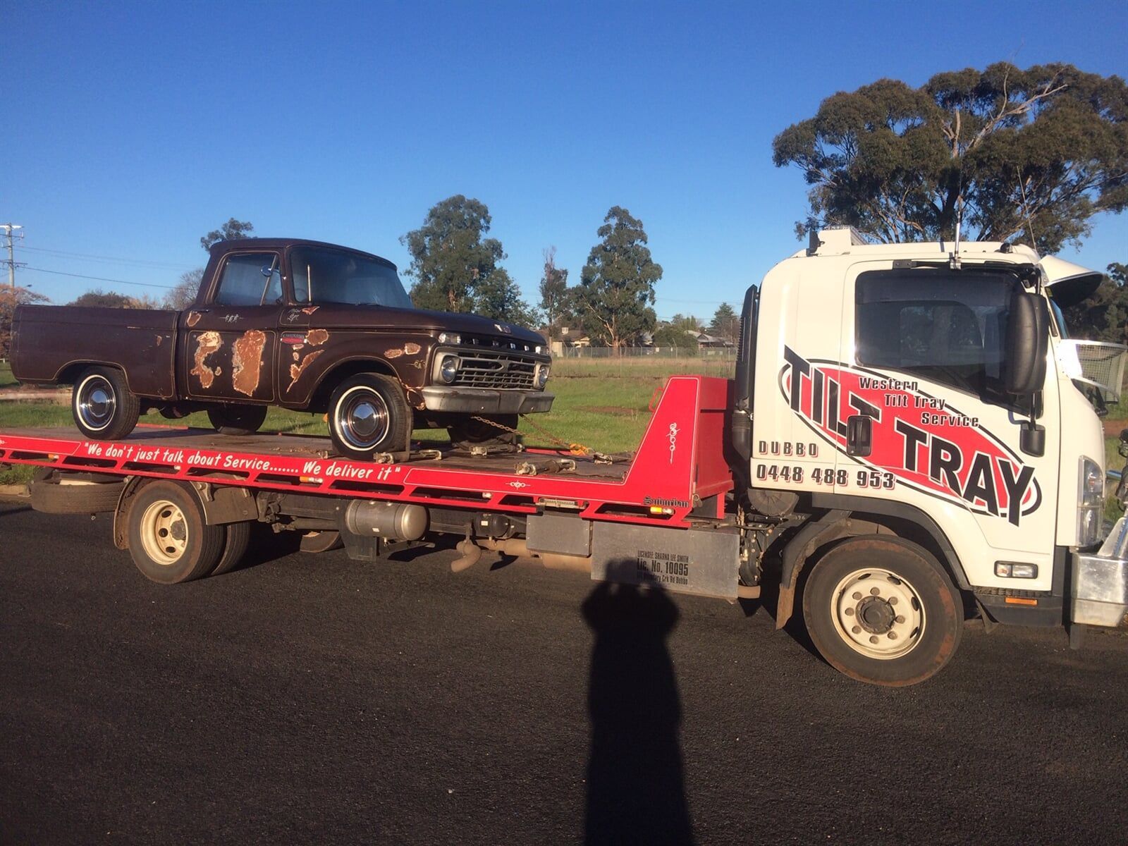 Truck towing red car — Towing in Bourke in Dubbo, NSW