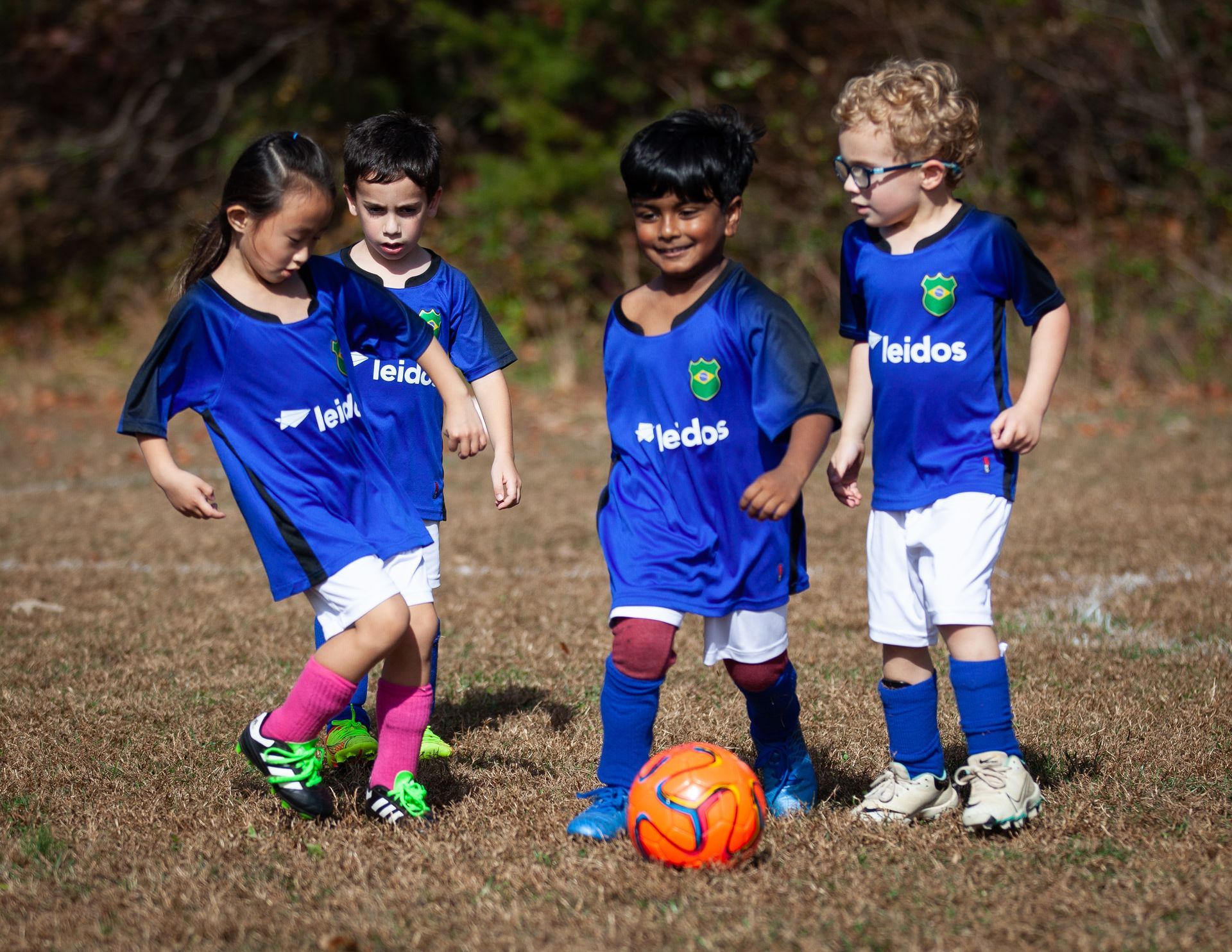 A group of young children playing soccer for Great Falls Reston Soccer Club
