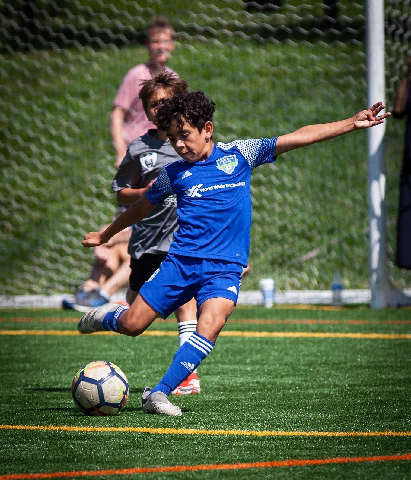 A young boy playing soccer for Great Falls Reston Soccer Club