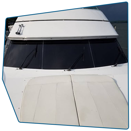 White boat deck and windshield with black glass; front view.