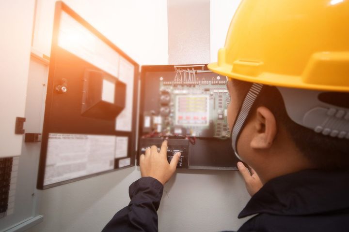 Electrician maintaining electrical box | Wingham, NSW | KMF Electrical & Solar