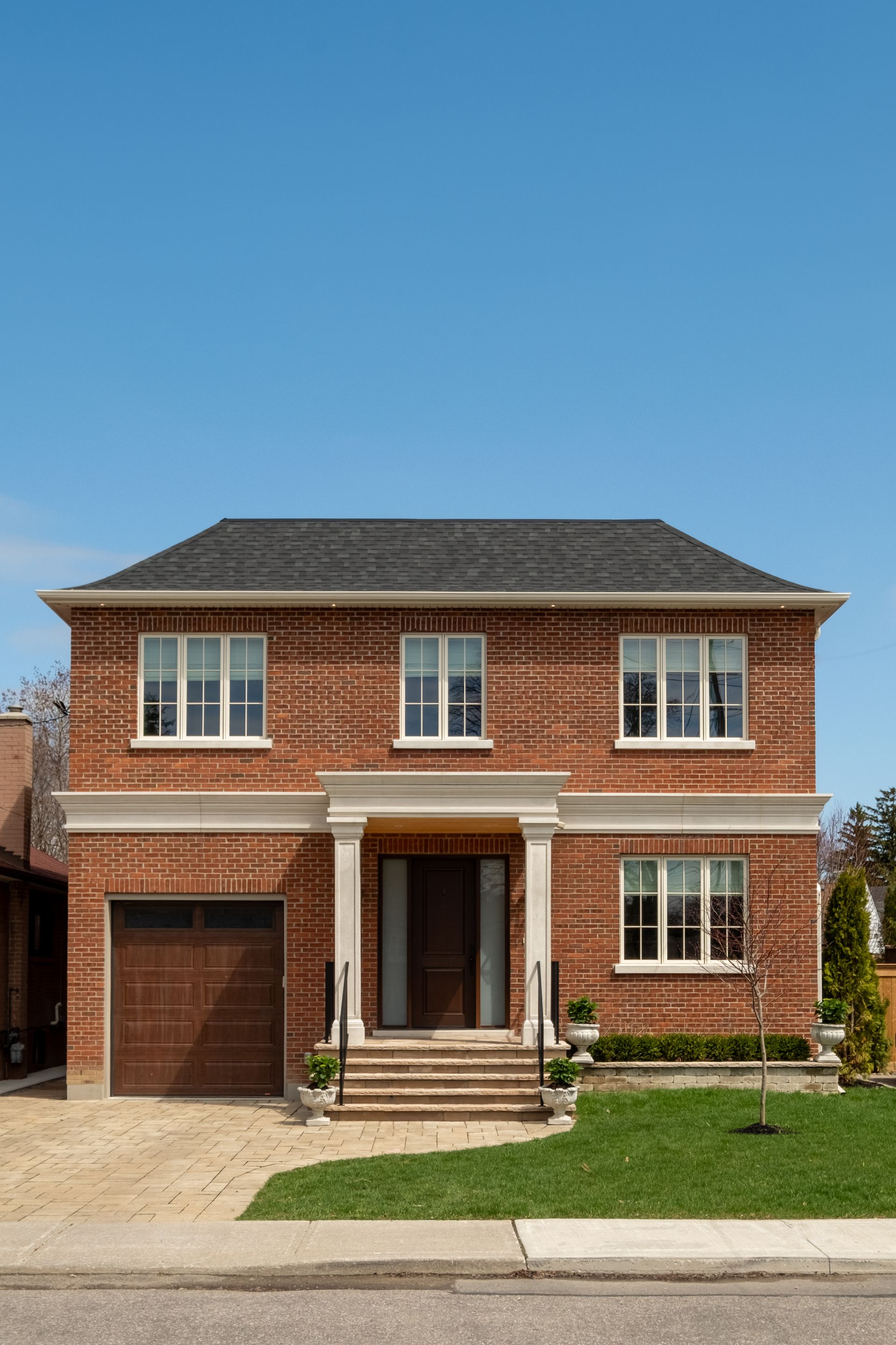 Two-story red brick house with garage and front porch