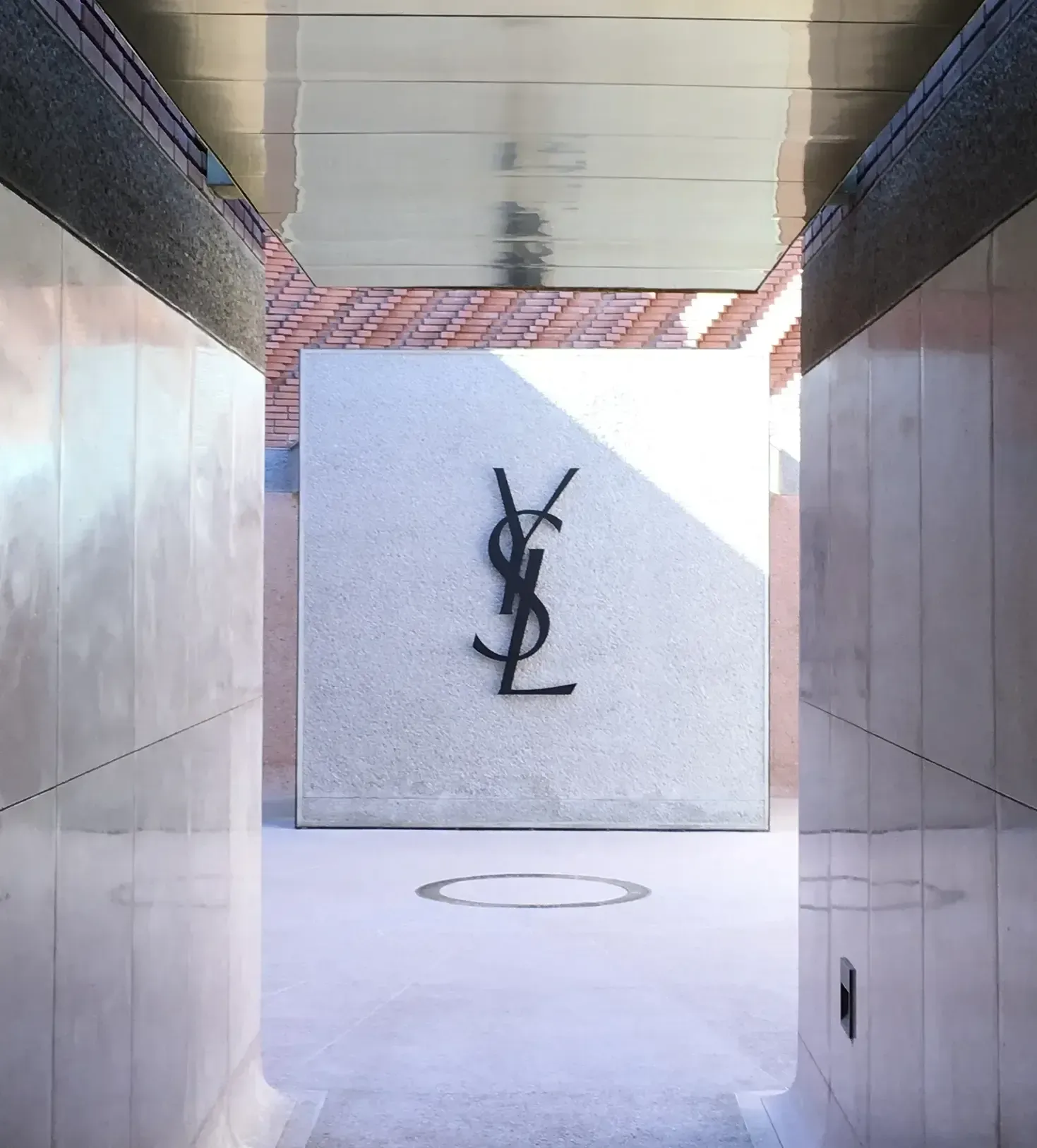 A hallway with a ysl logo on the wall