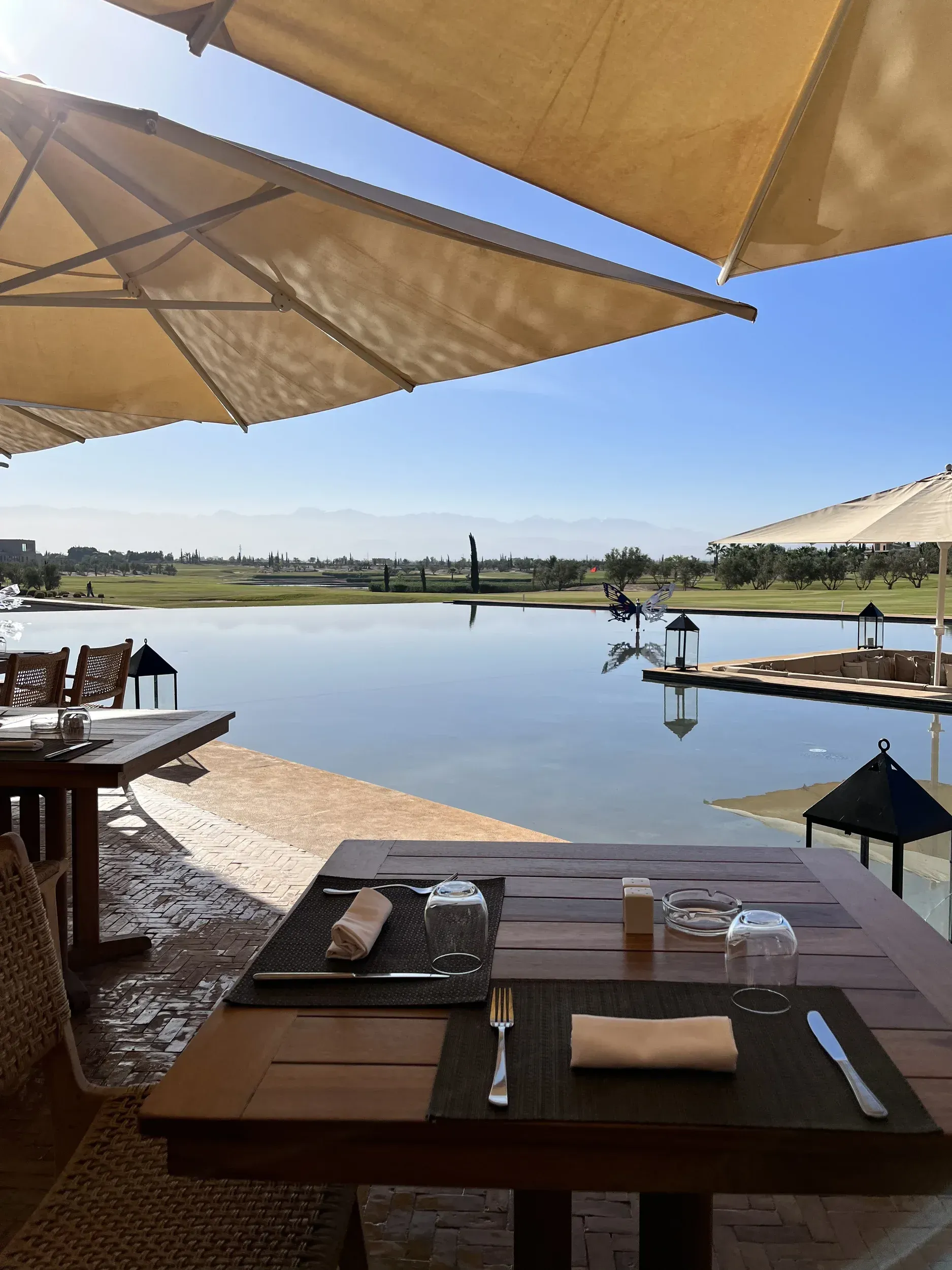 A table with umbrellas overlooking a large body of water
