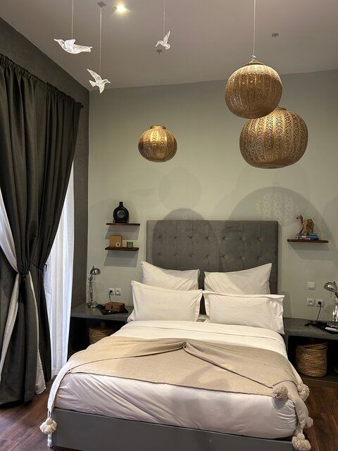 A bed with white sheets and pillows in a bedroom.