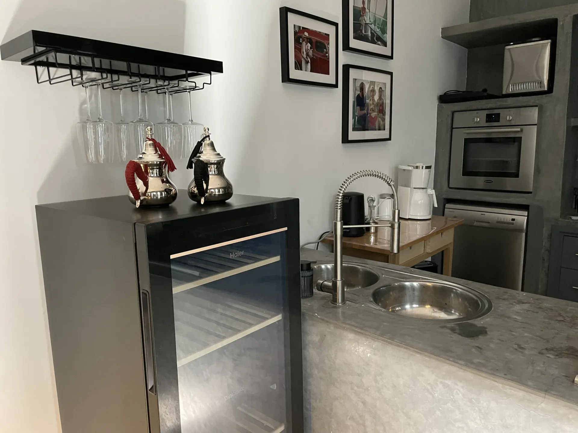 A kitchen with a wine cooler and a sink