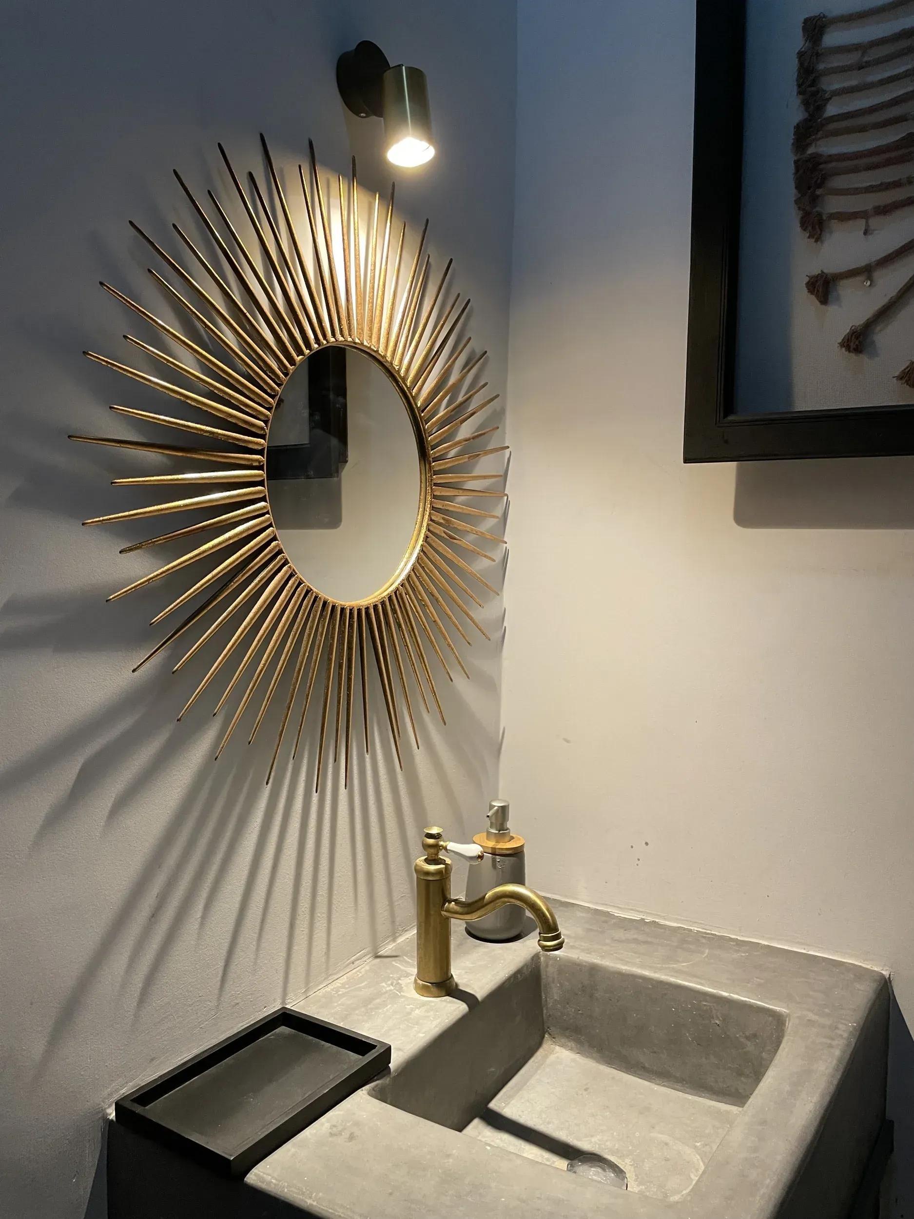 A bathroom with a sink and a mirror on the wall