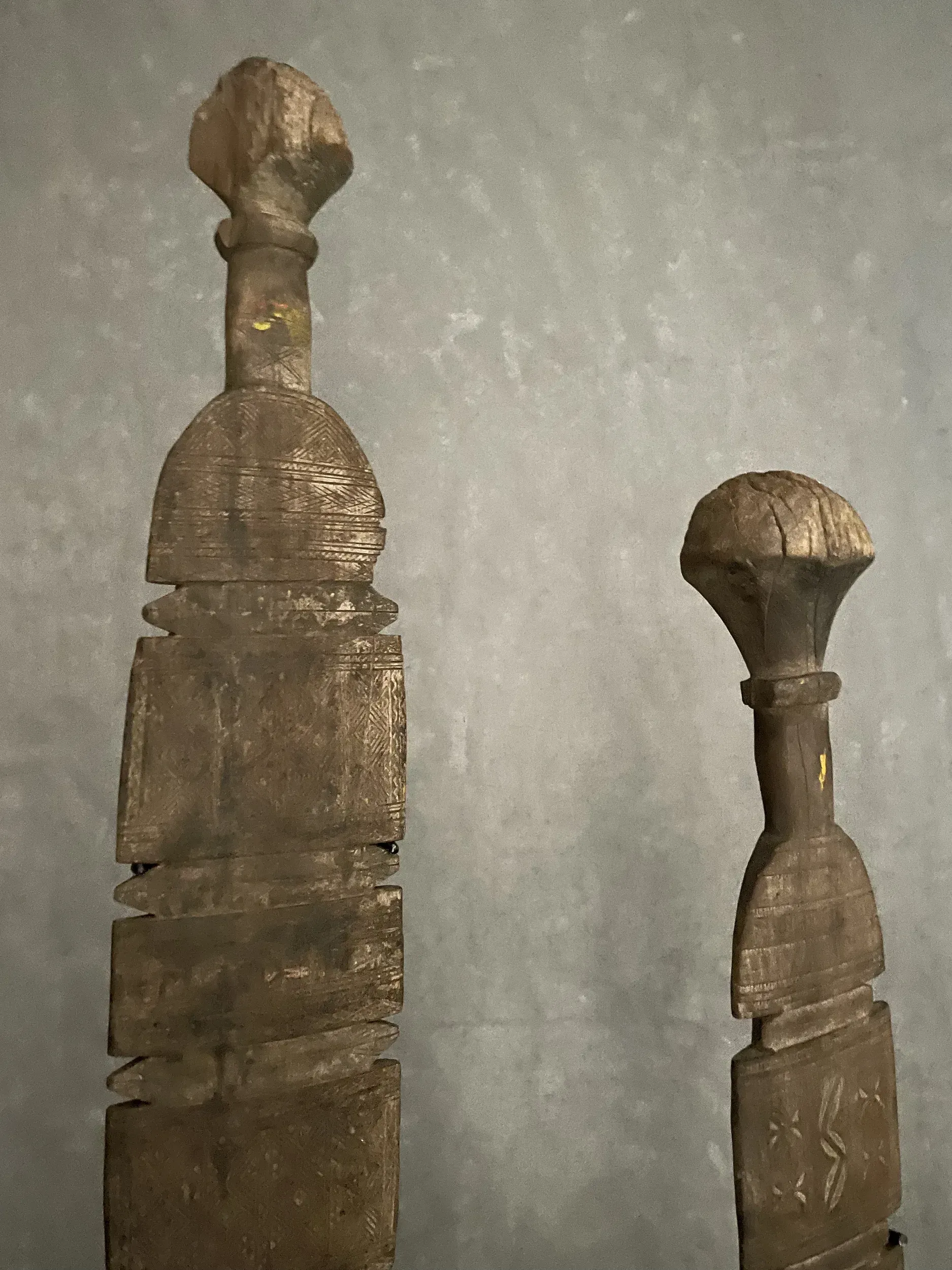 Two wooden sculptures are sitting next to each other on a table.