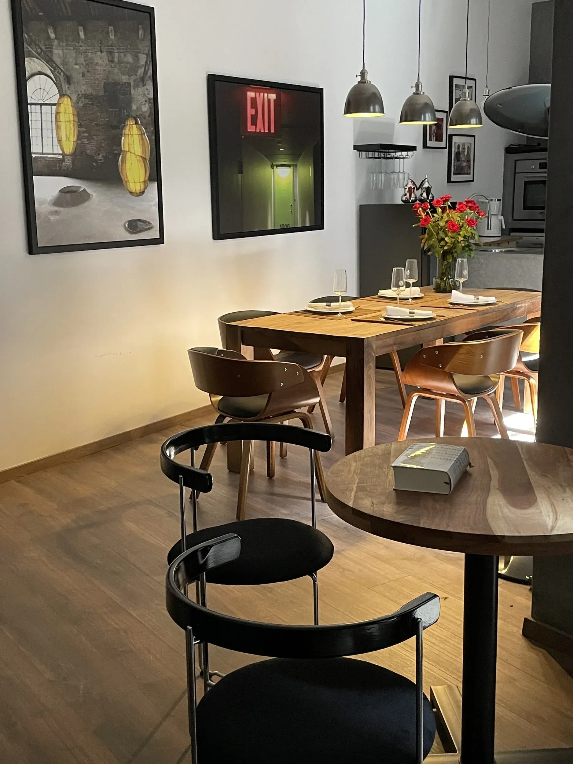 A dining room with a table and chairs and a sign that says exit