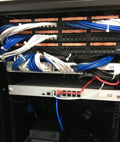 A network rack with patch panels, switches, and bundled network cables.