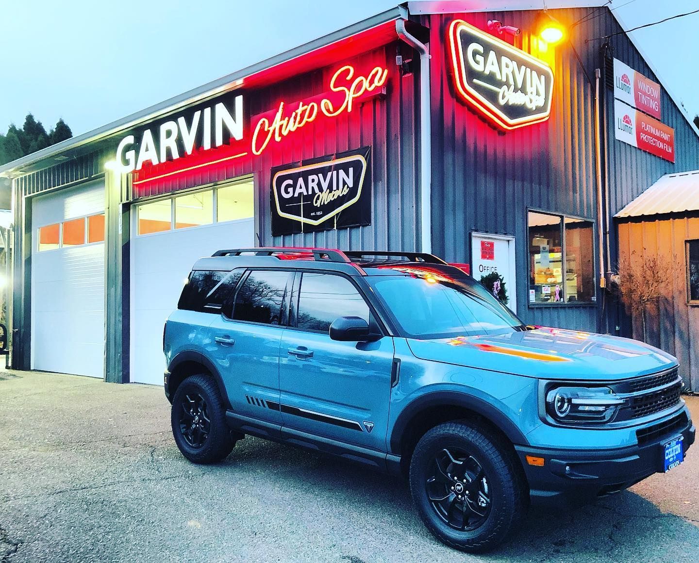 Blue Ford Bronco parked in front of