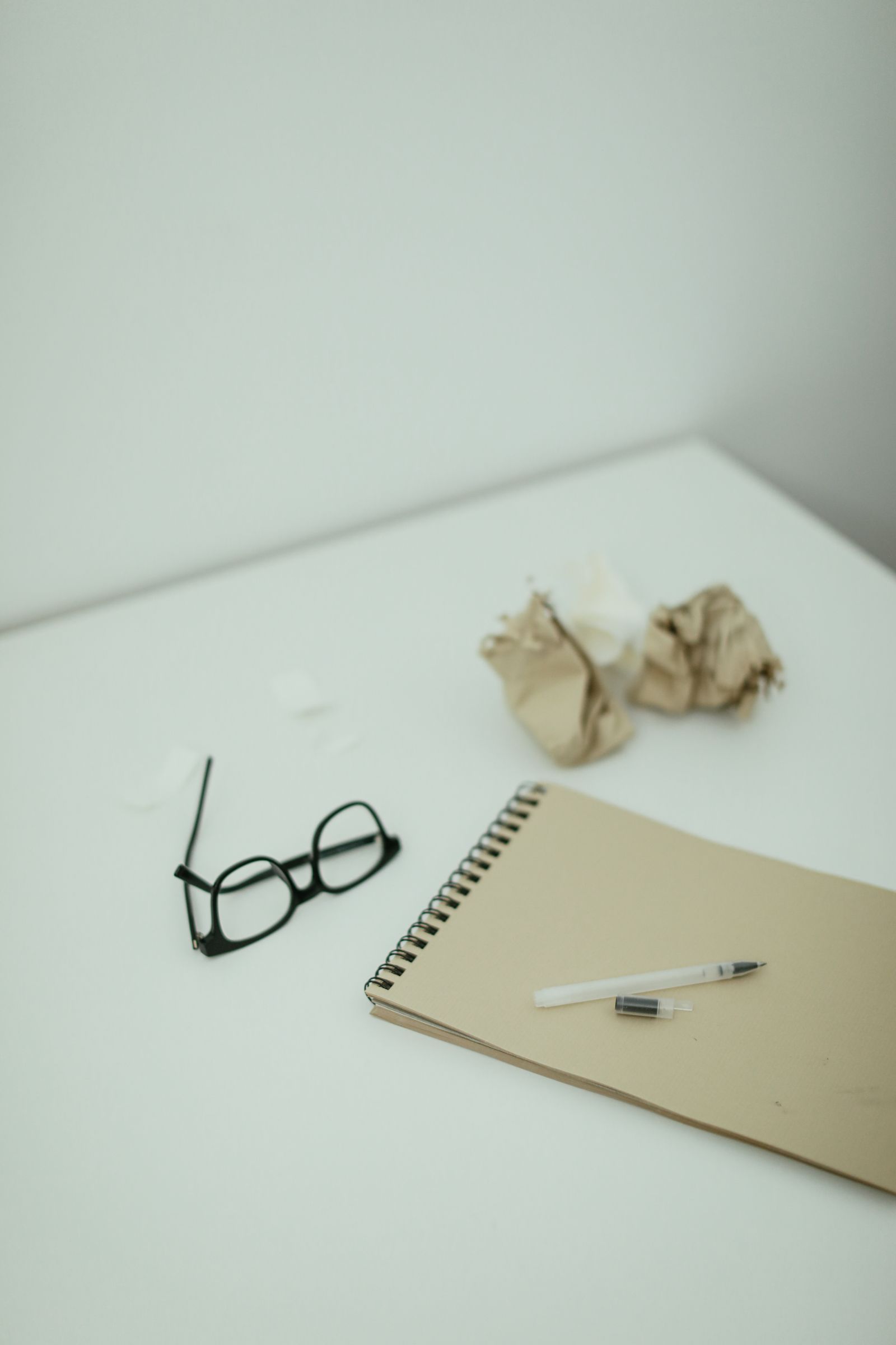An open notebook with reading glasses resting beside it