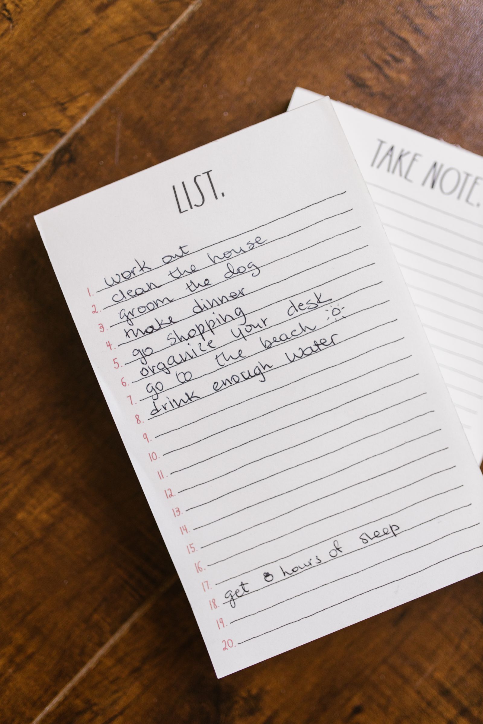 A handwritten list on a lined notepad