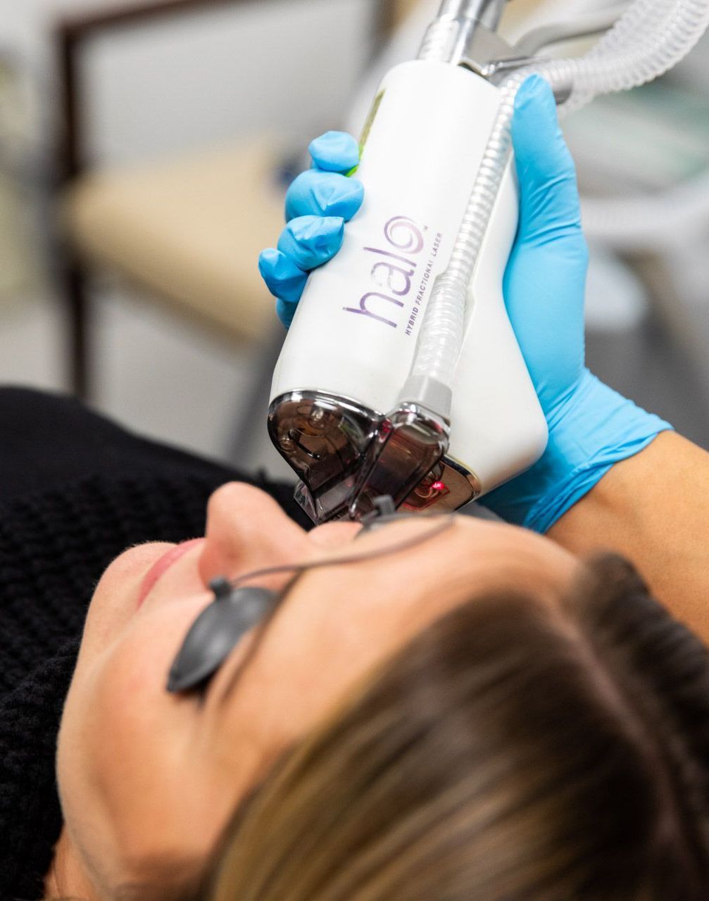 Woman receiving HALO Laser facial treatment at Skin & Soul Med Spa in Seabrook, TX.