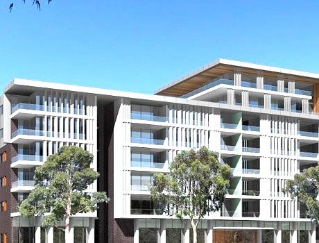 Modern multi-story apartment building with white balconies, wood accents, and trees in front